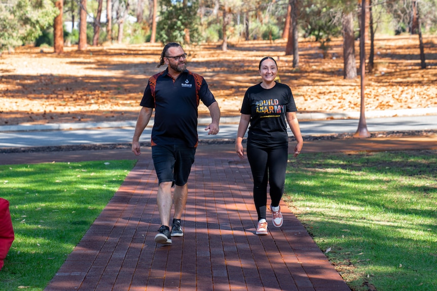 Aaron walking at Kulbardi with psychology student Sophia Allen