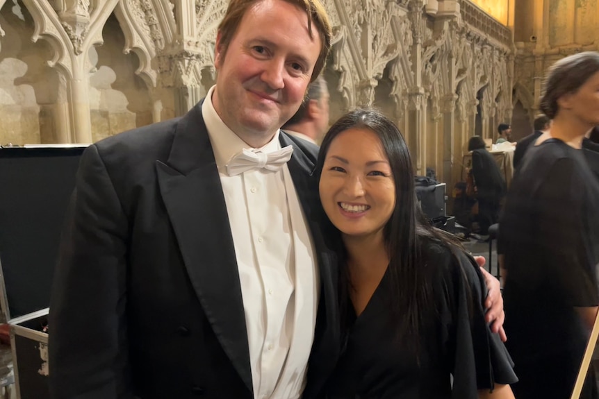 Violinist Naoko Keatley posing on the Maestro set. Her husband has his arm around her.