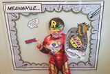 small child dress up as a superhero.