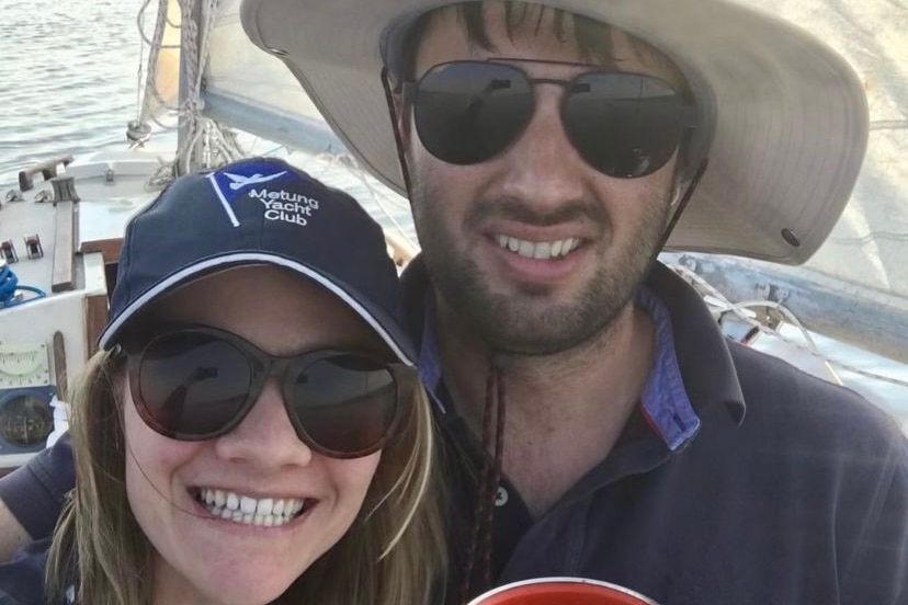 selfie of woman wearing a navy cap and sunglasses and a man wearing a hat and sunglasses. Both grinning widely, 