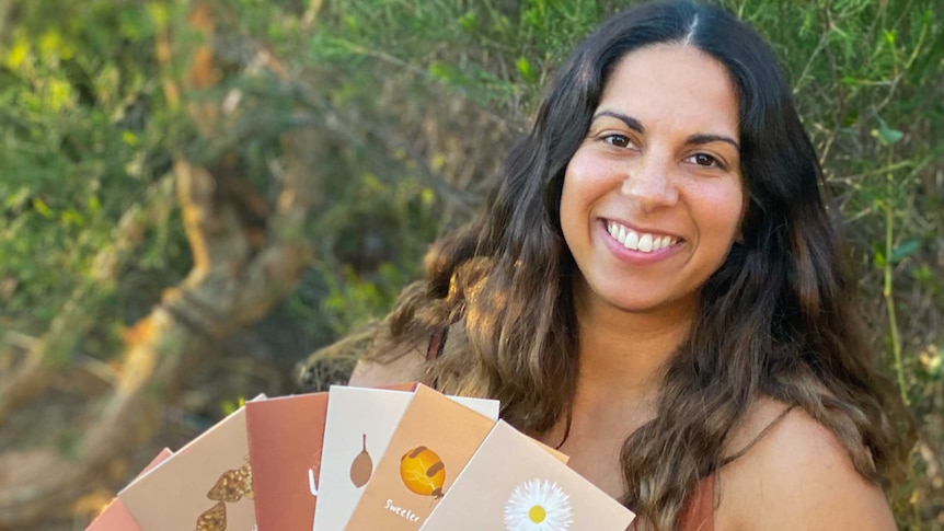 Aboriginal businesswoman Dana Garlett with some of the Greeting cards she's designed