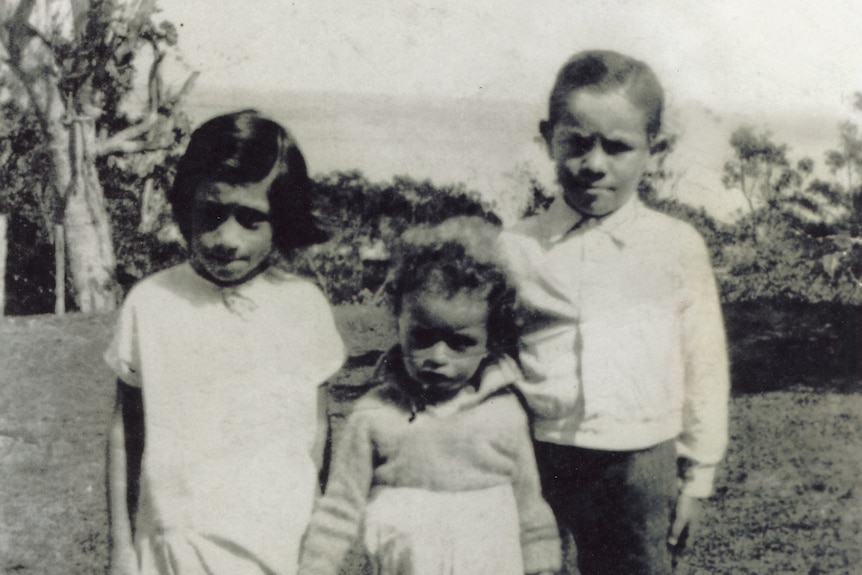 Twins Edmund and Eilene Brown pose with their little cousin Frazer at One Mile on North Stradbroke Island.