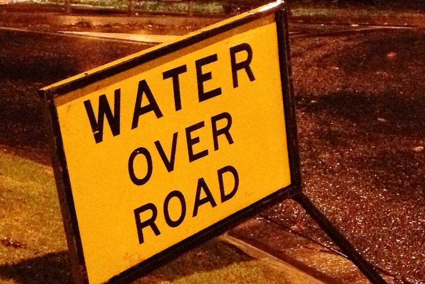 a road sign sating water over road
