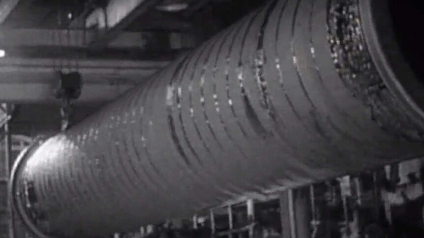 Water piping being wrapped in asbestos