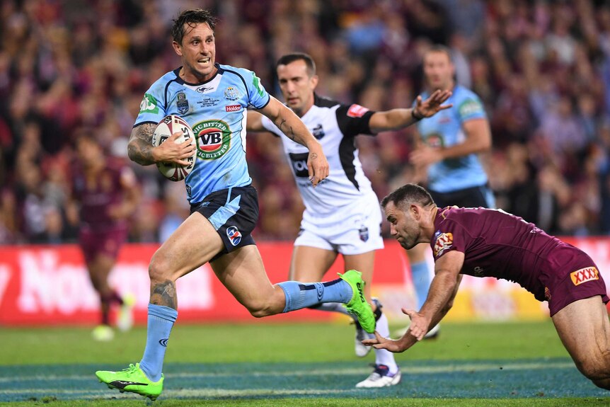 Mitchell Pearce runs away from a diving Cameron Smith in Origin I