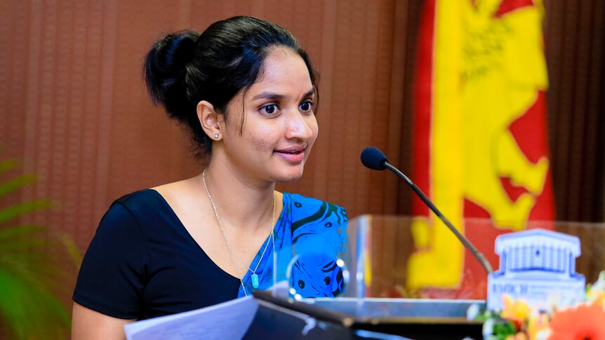 A Sri Lankan woman speaking into a microphone