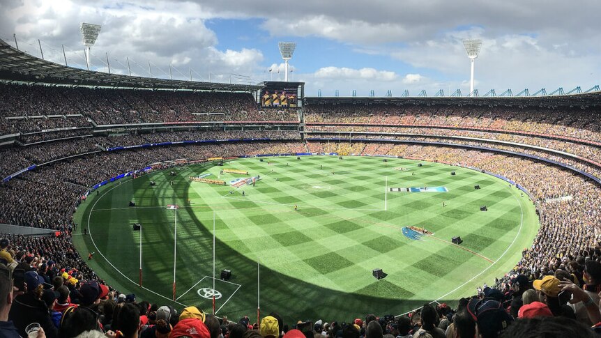 Full AFL stadium overlooking crowd and AFL field