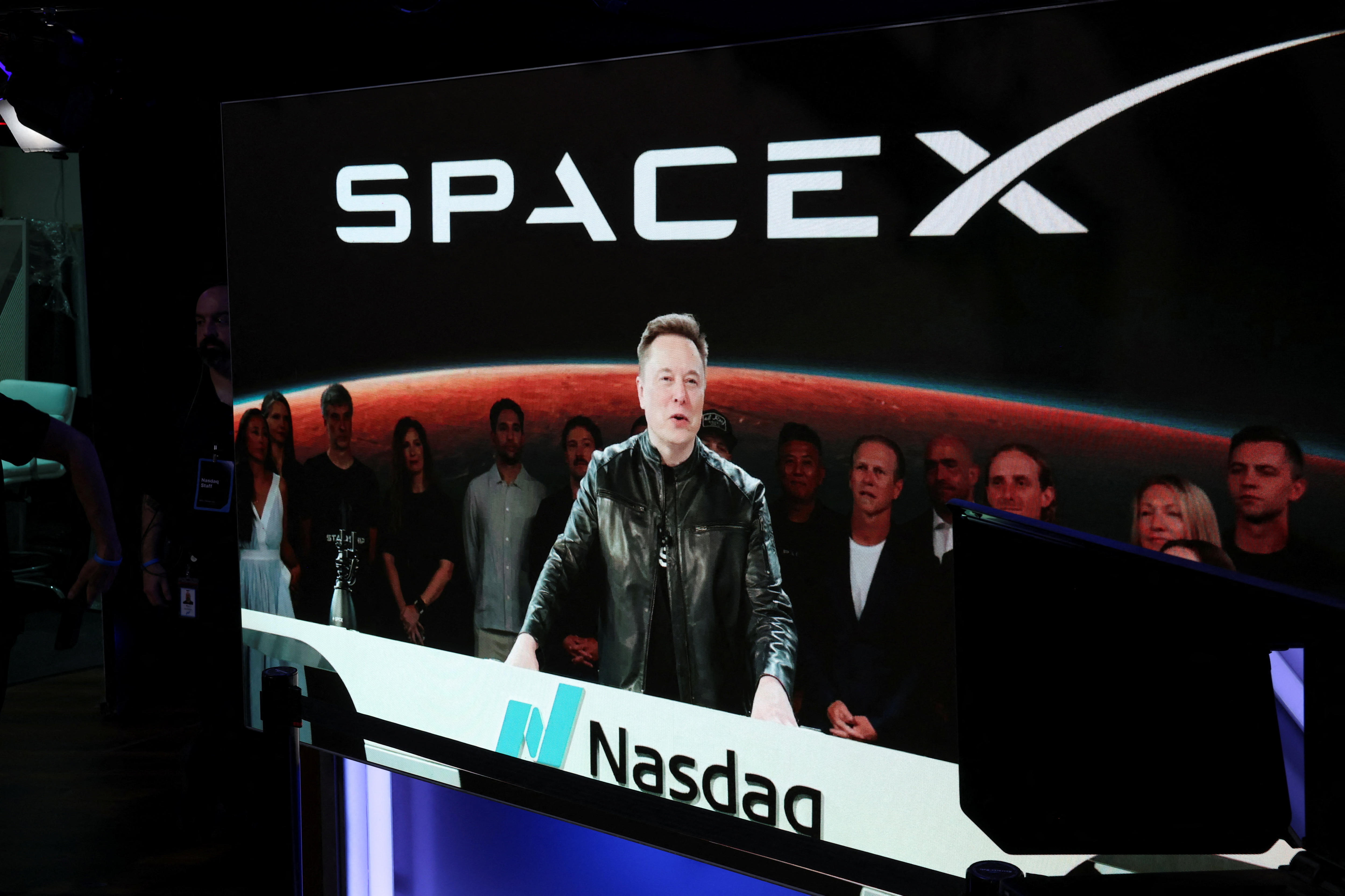 Elon Musk speaks in front of a crowd