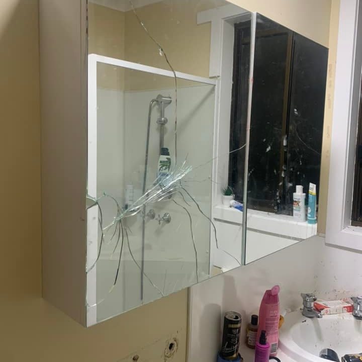 A bathroom cabinet mirror in a social housing unit smashed 