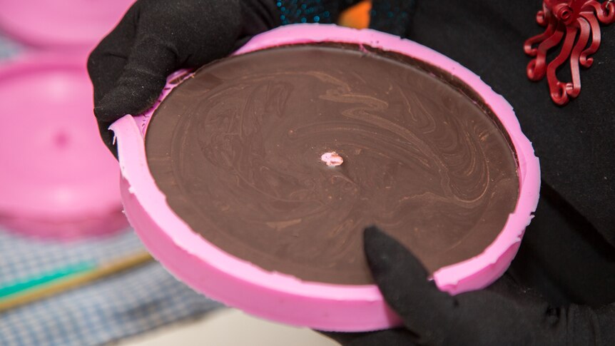 The frozen chocolate record has swirling textures on the top and the grooves of the sound on the other side.