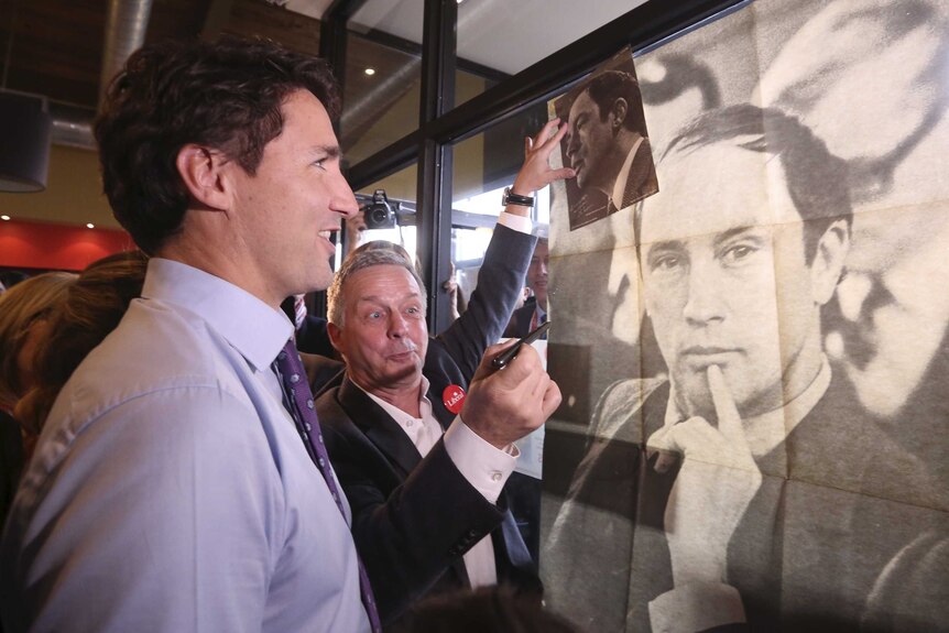 Justin Trudeau and poster of his father Pierre Trudeau