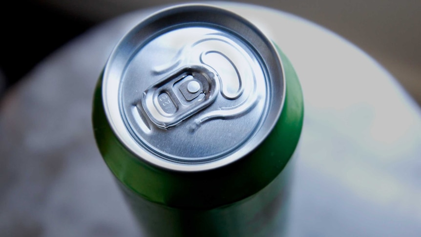 A green energy drink can seen from above its pull tab