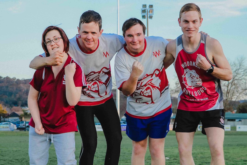 Four players smile at the camera for Becoming Bulldogs  movie poster