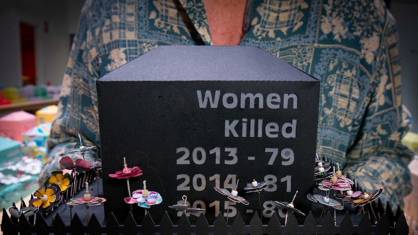 A black cardboard memorial with a picket fence lists the women killed in 2013 as 79, in 2014 as 81 and in 2015 as 80.