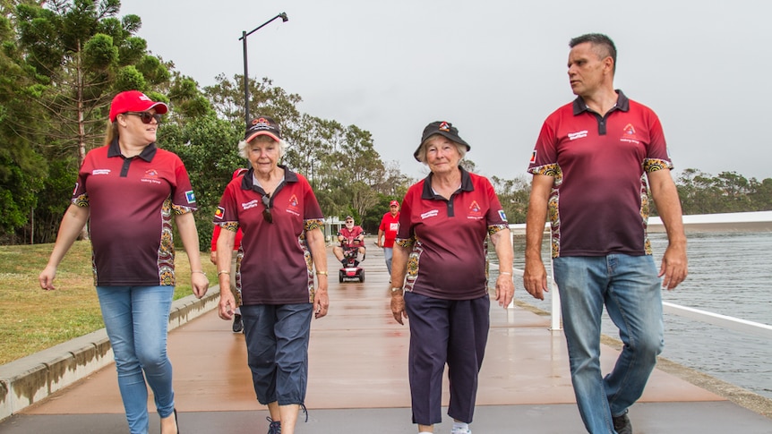 Young and old walkers stroll along the footpath at Moreton Bay.