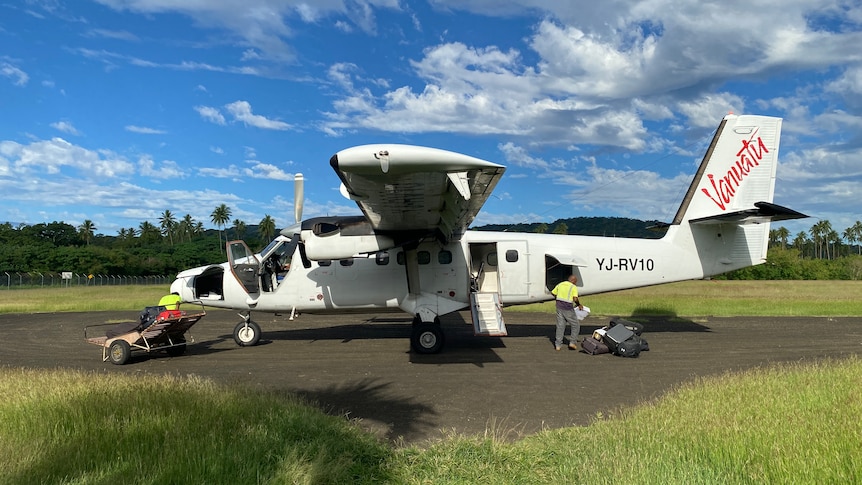A small plane is loaded up on an outer island in Vanuatu.