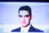 A photo of Jordanian Humam Khalil Abu Mulal al-Balawi is broadcast by Al-Jazeera