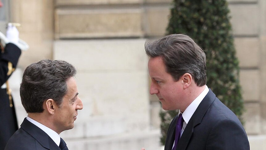 Nicolas Sarkozy shakes hands with David Cameron