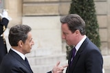 Nicolas Sarkozy shakes hands with David Cameron