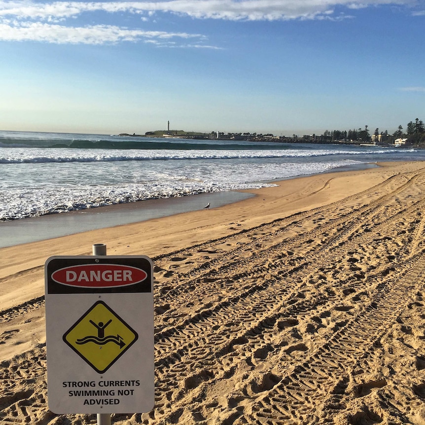 A warning sign for strong currents on North Wollongong Beach.