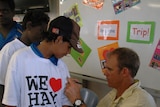 Matthew Hayden signs a shirt during his visit to the Tiwi Islands in November last year.