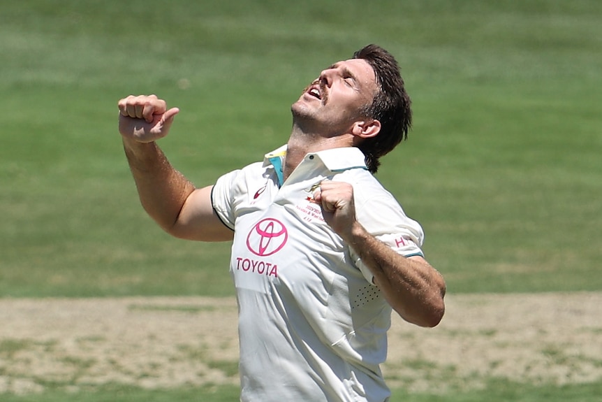 Mitch Marsh holds his head back and clenches his fists