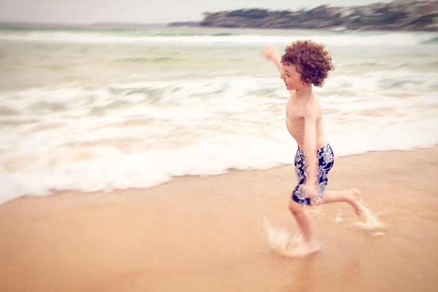 Child runs on the beach