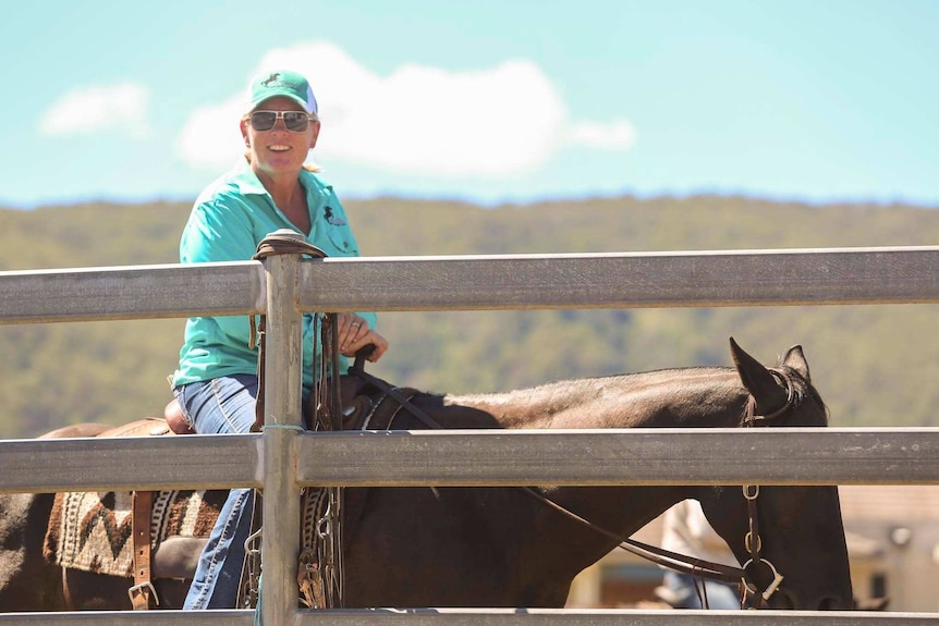 Tanya Thomson sits on a horse smiling