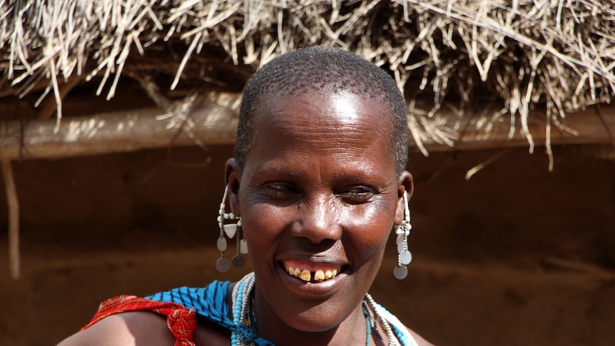 A woman selling trinkets at an African cattle market