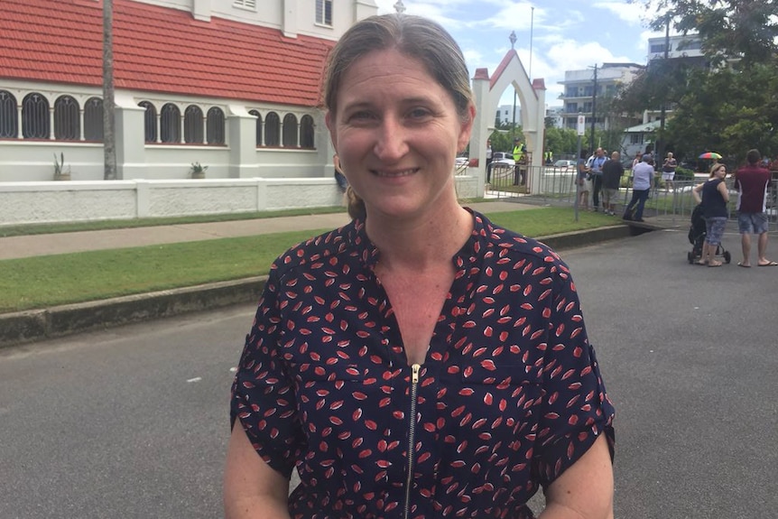 Alycia Lone stands outside a church in Cairns, waiting for Prince Charles to arrive for his visit on April 8, 2018.