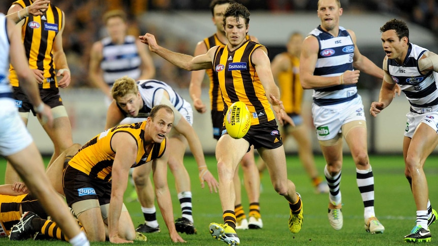 Isaac Smith has a shot for goal for Hawthorn against Geelong in the 2013 preliminary final.