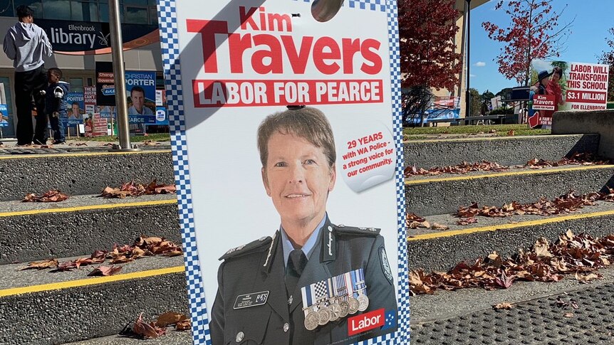 A polling poster with an image of a police officer.
