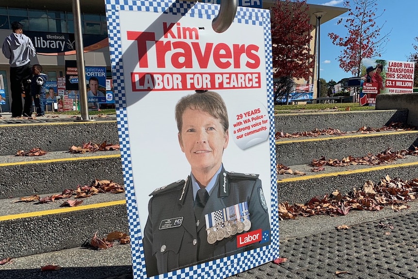 A polling poster with an image of a police officer.