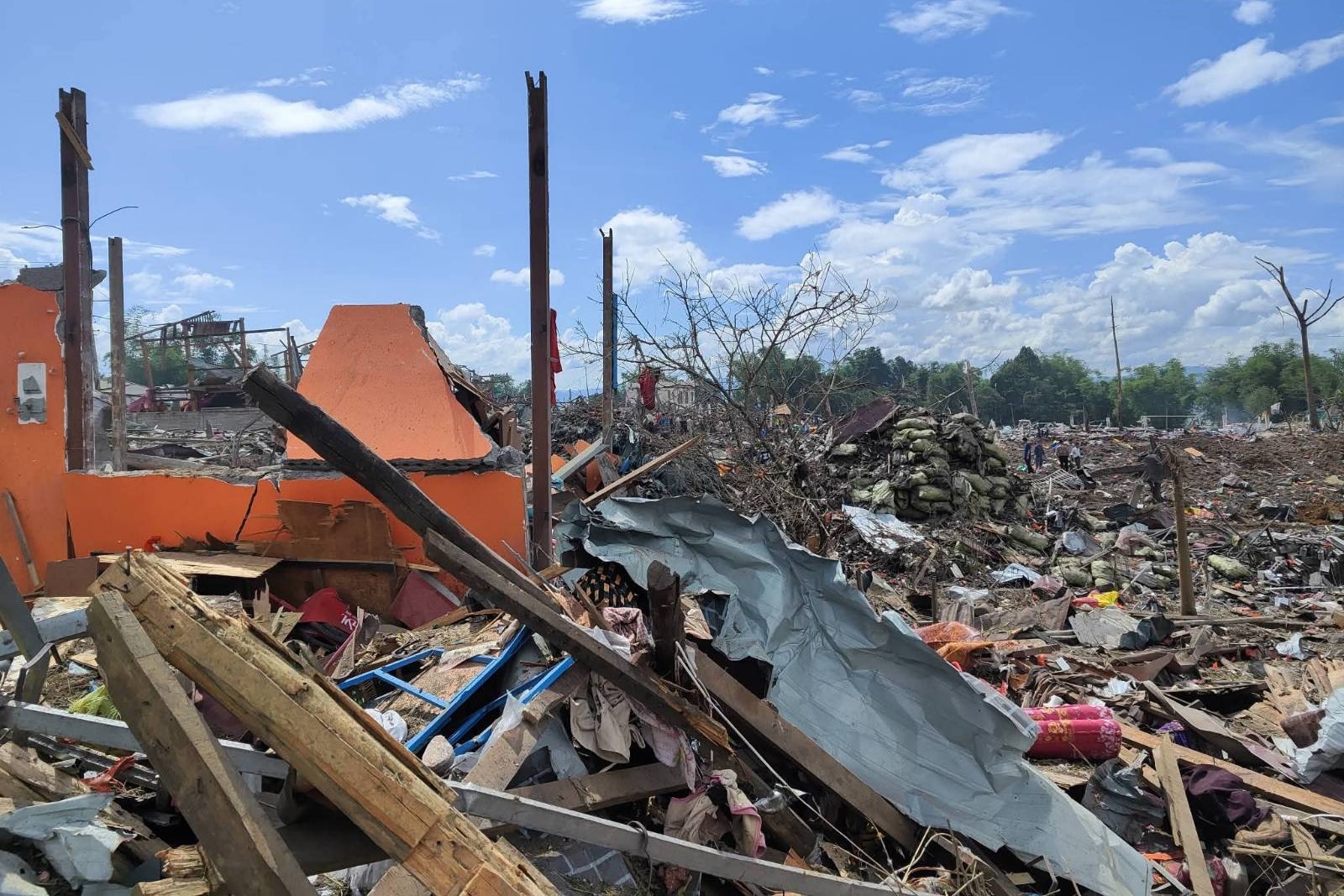 A wide shot of a village showing just debris and flattened houses.