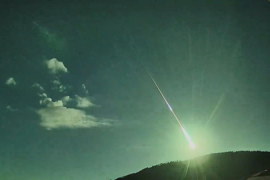 The night sky with a green hue from a comet