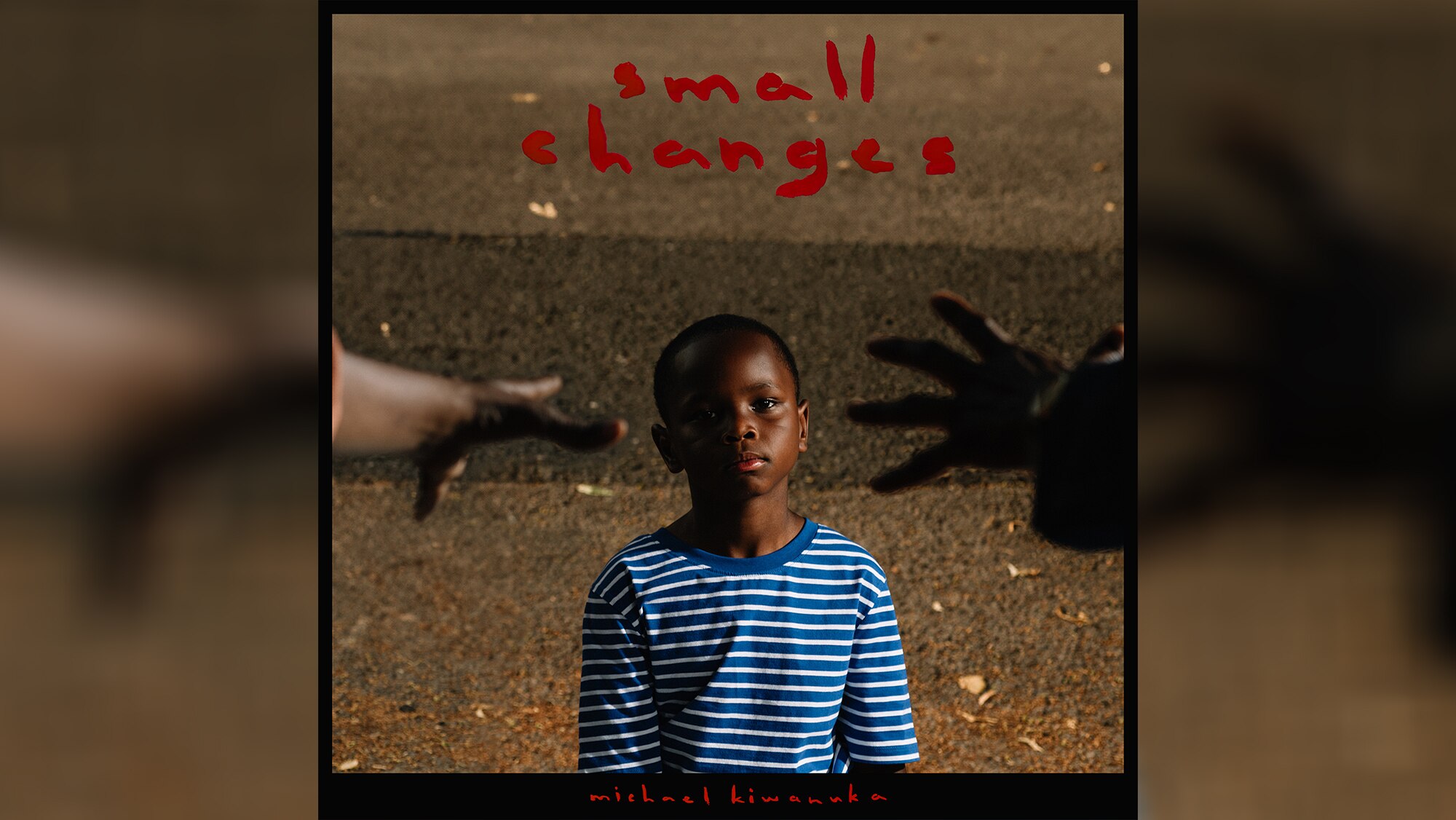 Two hands reach in out of frame for a young Black boy wearing striped blue shirt. Text: Small Changes, Michael Kiwanuka