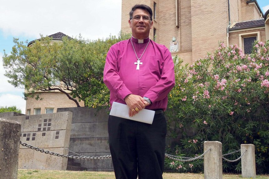Bishop of Bunbury Allan Ewing standing outside a church.