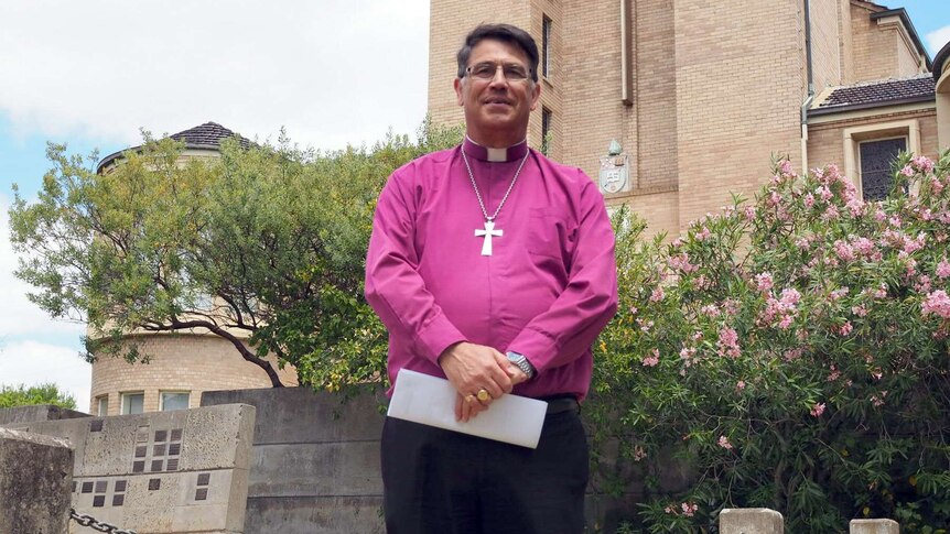 Bishop of Bunbury Allan Ewing standing outside a church.