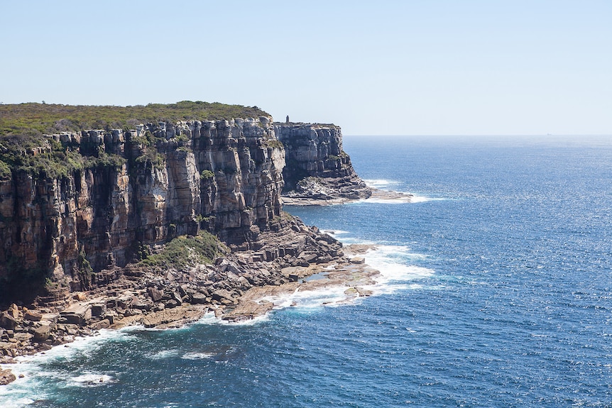 A sheer cliff going into the ocean.