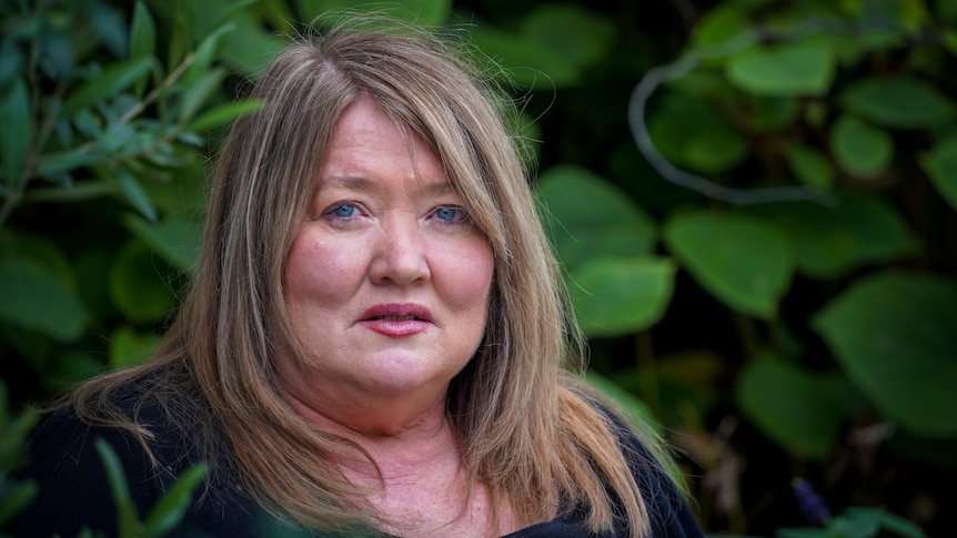 A profile photo sexual assault survivor Megan with garden behind her