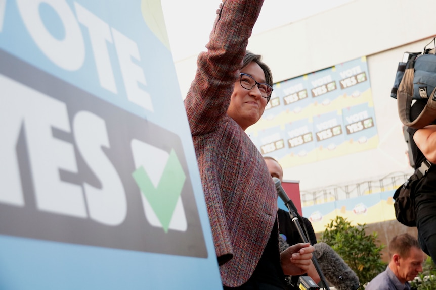Penny Wong waves to a crowd.