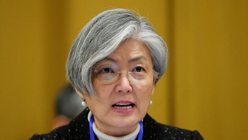 Close up of South Korean Foreign Minister Kang Kyung-Wha against a yellow background