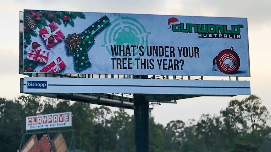 Large billboard with a wrapped gun pictured.