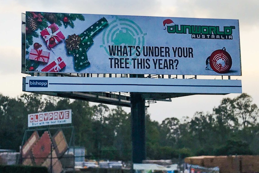 Large billboard with a wrapped gun pictured.