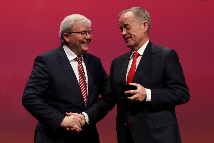 Kevin Rudd and Bill Shorten smile in front of a red background