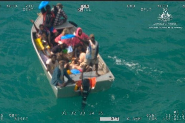 Camera still of people stranded in a small boat at sea