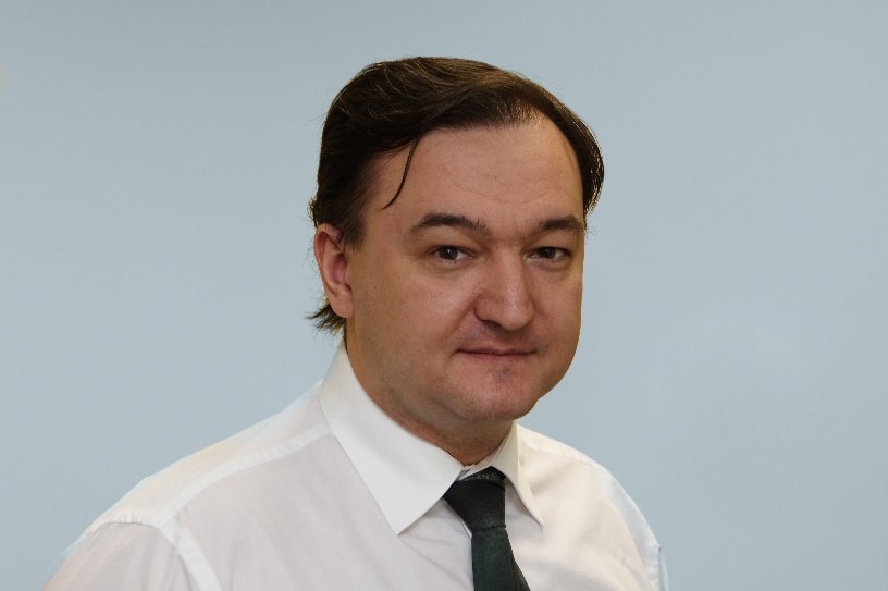 Head shot of Russian tax lawyer Sergei Magnitsky, in a white shirt and black tie