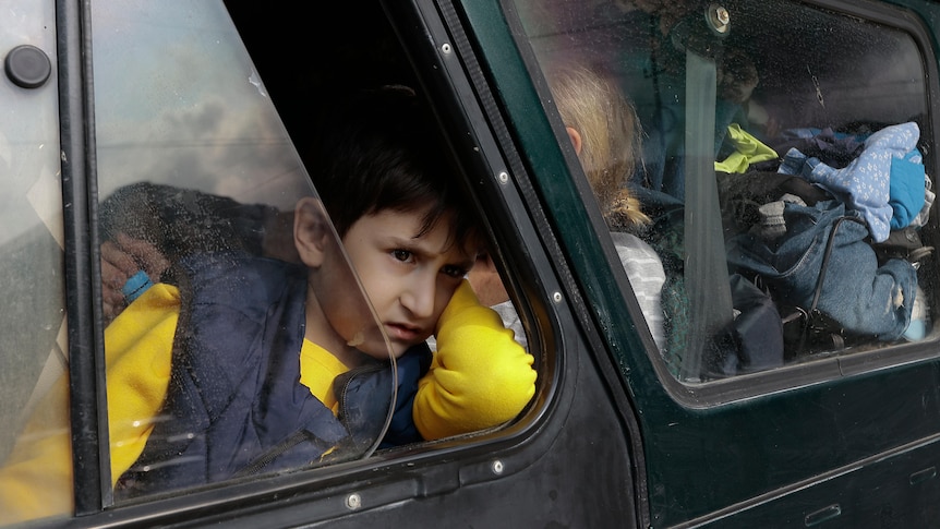 An ethnic Armenian boy from Nagorno-Karabakh, looks on from a car upon arrival in Armenia.