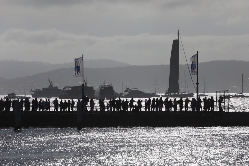 Crowds gather at the docks to see the first yachts come in during the 2018 Sydney to Hobart.