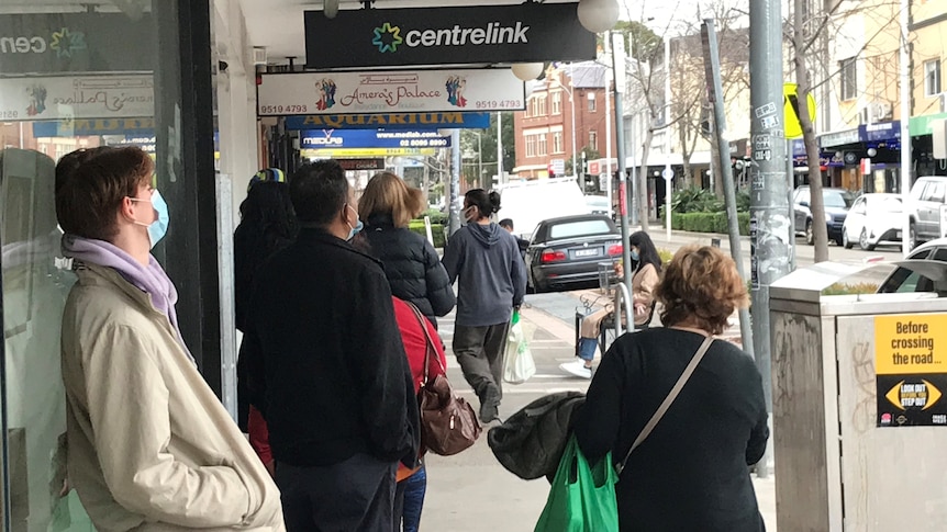 People wait in a Centrelink queue in the Sydney suburb of Marrickville.